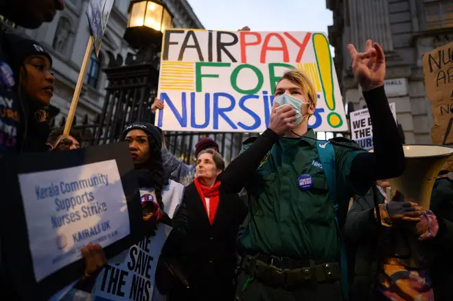 An ambulance paramedic makes a speech as NHS workers and supporters gather outside Downing Street