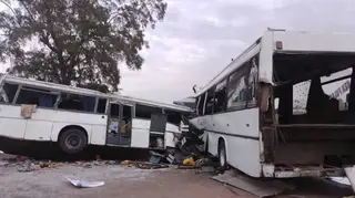 Two damaged buses are pictured after they collided on a road in Gniby, Senegal