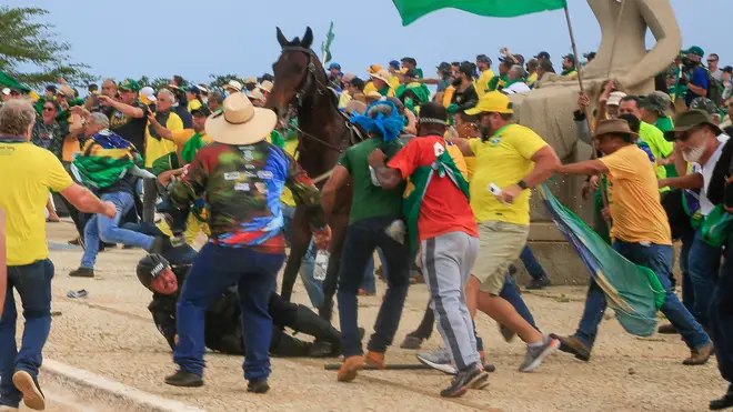 Mounted police clash with rioters at the presidential palace in capital Brasilia