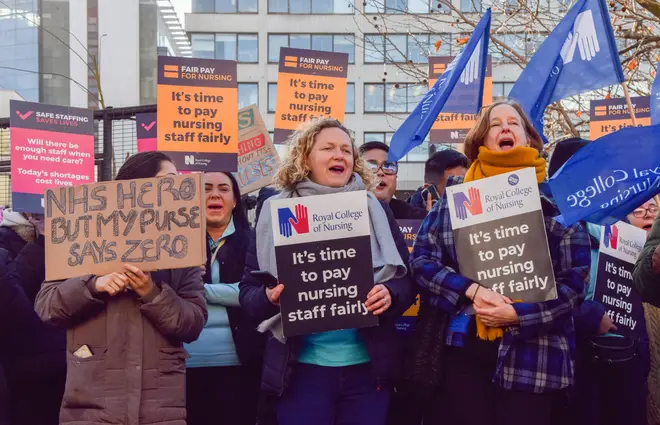 Nurses hold placards in support of fair pay during the demonstration at the picket line outside St Thomas' Hospital, December 20, 2022.