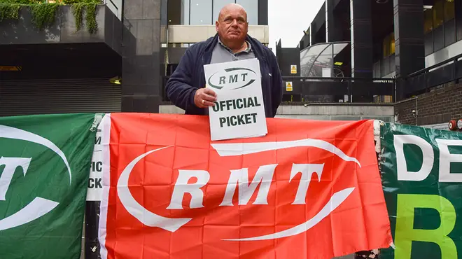 RMT banner with man picketing for rail strike