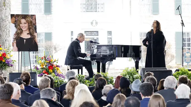Alanis Morissette performs onstage during the memorial service