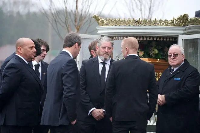 Elle Edwards' dad Tim surrounded by mourners