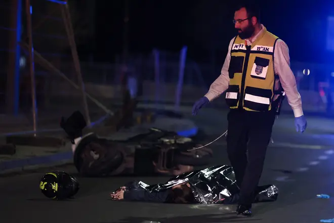 Israeli emergency service personnel rush near casualtie