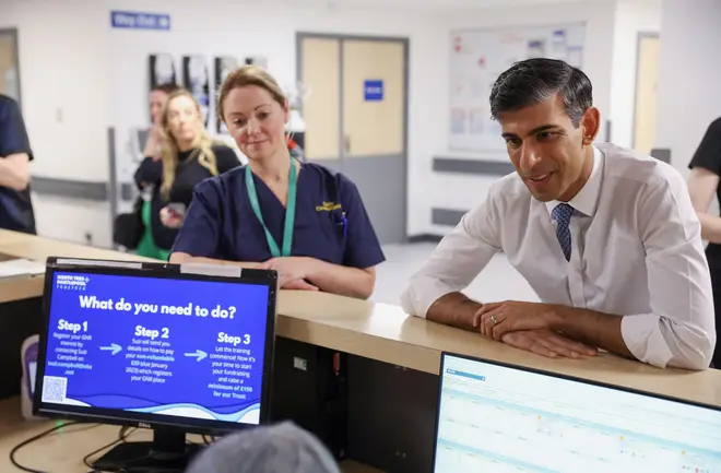 Prime Minister Rishi Sunak speaking to a staff member during his tour of University Hospital of North Tees, as part of his visit to County Durham.