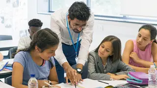 Male teacher in classroom with his students