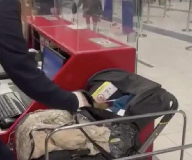 Shocking footage showed the moment check-in staff found the baby inside the pushchair