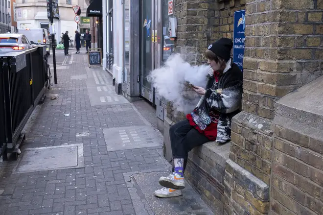 A woman seen vaping in Soho, central London