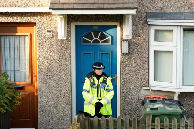 Police guarding the house where three children were stabbed