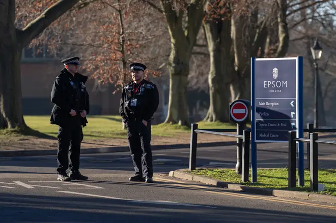 Police officers stand guard inside Epsom College after the school's head, Emma Pattison, was found dead alongside her family