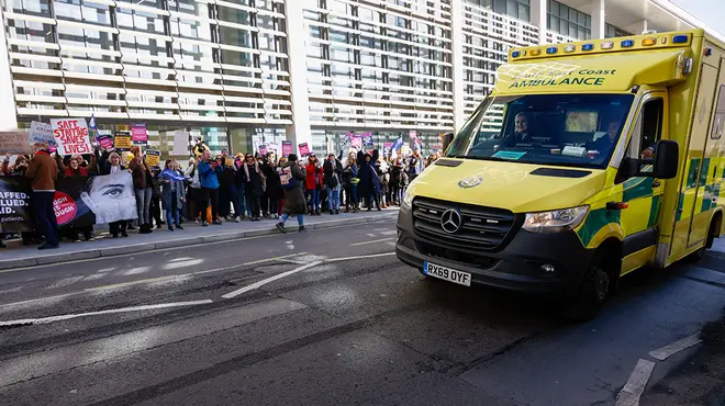 Ambulance driving past striking workers