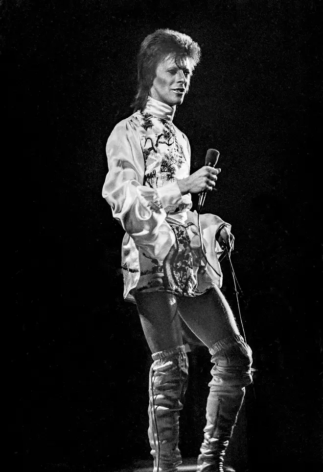 David Bowie, dressed as his Ziggy Stardust character, performs live on stage at Earl's Court Arena, London, on the opening night of the Aladdin Sane UK Tour on 12th May 1973.
