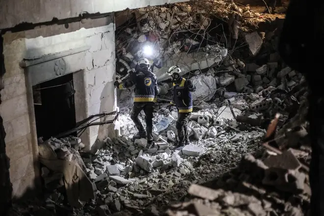 Rescuers search through the rubble in Idlib, Syria, February 9.