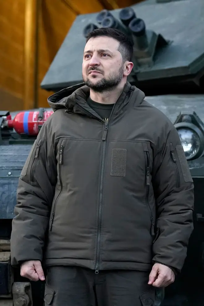 Ukraine's President Volodymyr Zelensky reacts as he meets with Ukrainian troops being trained to command Challenger 2 tanks at a military facility in Lulworth, Dorset in southern England on February 8, 2023.