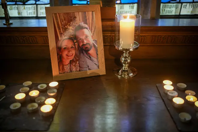 Candles illuminate a photo of missing woman Nicola Bulley and her partner Paul Ansell at St Michael's Church
