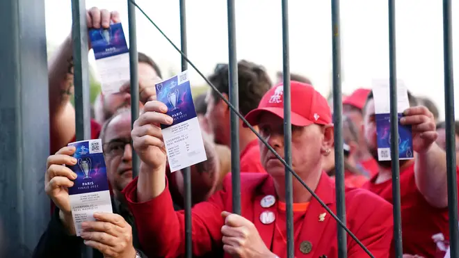 Liverpool fans stuck outside the ground showing their match tickets during the UEFA Champions League Final