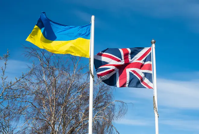 Ukrainian flag and British Union Jack flag flying together in UK, West Sussex, April 2, 2022.