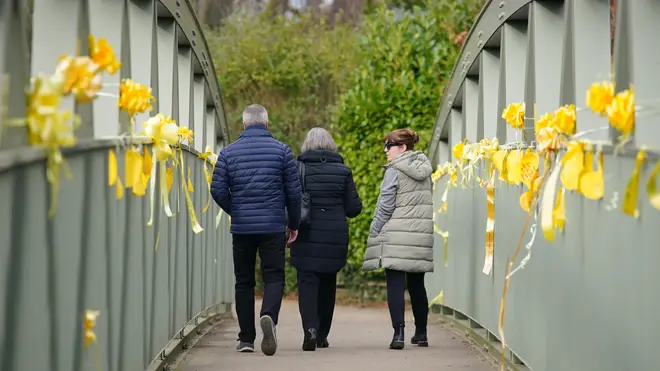 Yellow ribbons and messages of hope tied to a bridge over the River Wyre in St Michael's on Wyre