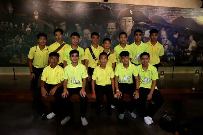 Members of the Wild Boars soccer team pose for a photo during a return to the Tham Luang caves in 2019.