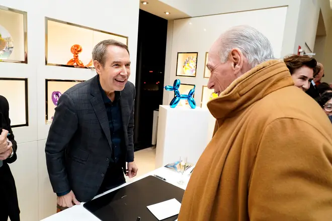 Jeff Koons speaks to a fan with the piece in the background November 15, 2021 in New York City.