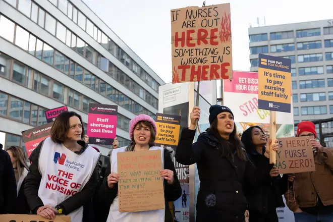 Nurses hold up placards expressing their opinion during the demonstration outside St Thomas' Hospital, February 7, 2023.