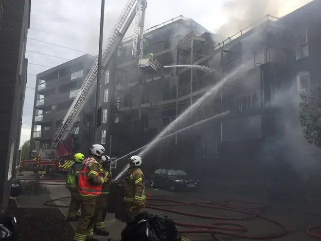 Firefighters tackle the six-story flat fire in Barking