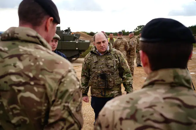 Mr Wallace speaking to a tank crew in Dorset