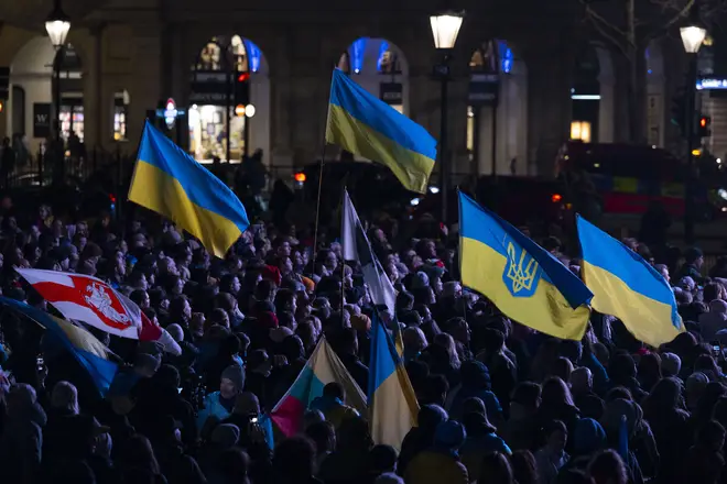 People, holding Ukrainian flags and banners, attend the solidarity event with Ukraine organized by the Ukrainian and US embassies in London to mark the first anniversary of the war between Russia and Ukraine