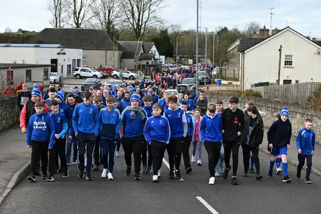 Boys from Beragh Swifts football club lead a walk of solidarity in support of Detective Chief Inspector John Caldwell who was shot while attending a Beragh Swifts football coaching session with his son, on February 25, 2023 in Omagh, Northern Ireland.