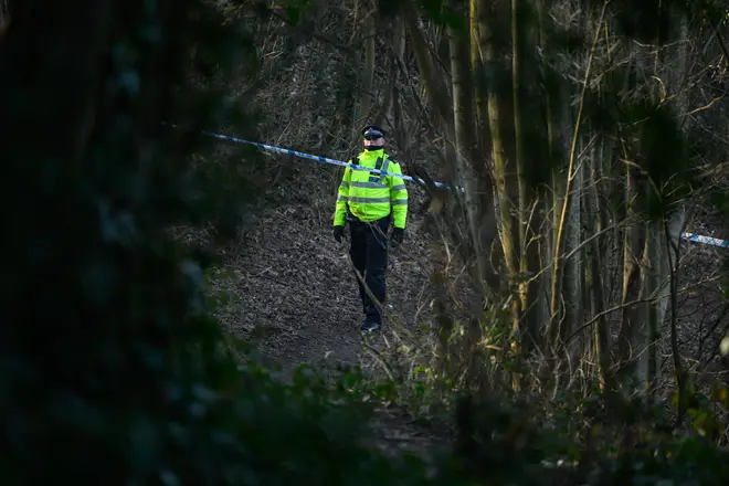 A police officer stands at a cordon around the location where it is believed the body of a baby was found