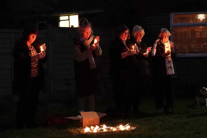 Mourners holding candles at the vigil