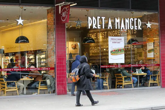 A woman walks past a branch of Pret A Manger in London...