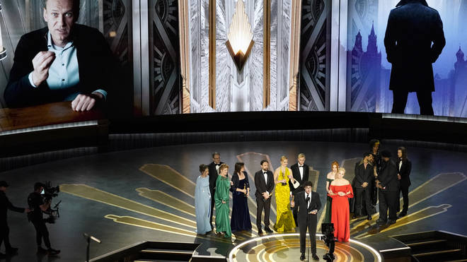 Daniel Roher and the members of the crew from Navalny accept the award for best documentary feature film at the Oscars at the Dolby Theatre in Los Angeles