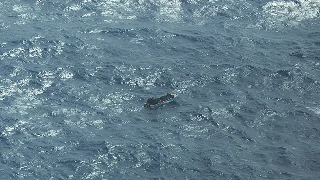 This image provided by German humanitarian organisation Sea-watch shows a boat carrying a group of migrants in distress in the southern Mediterranean Sea