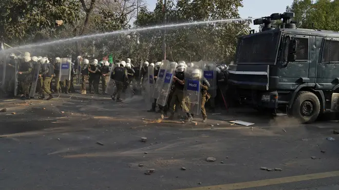 Police use water cannon to disperse the supporters of former prime minister Imran Khan during clashes outside Mr Khan’s residence in Lahore, Pakistan