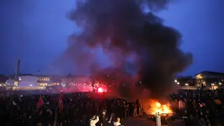Pallets burn as protesters demonstrate at Concorde square near the National Assembly in Paris