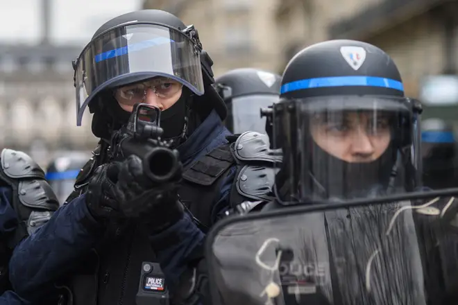 Riot police fired tear gas to move protesters away from the Elysee Palace