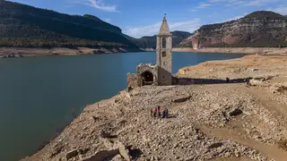 A church and remains of an ancient village which are usually covered by water are seen inside the reservoir of Sau, in Vilanova de Sau, Catalonia, in November 2022