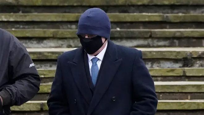 Michael Lawrence is pictured with his face covered at a prior court appearance