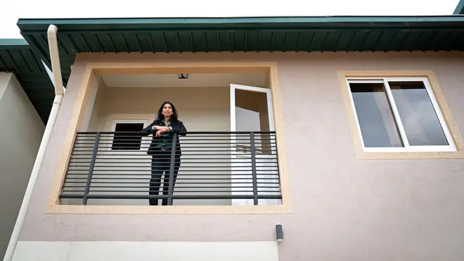 Braverman poses for pictures on the balcony of one home which may become housing for migrants