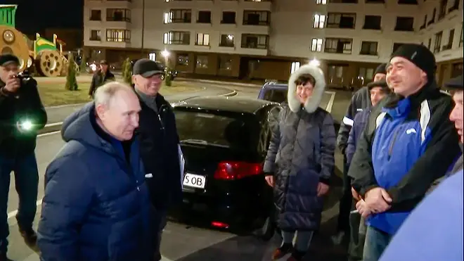 Putin talks with local residents during his visit to Mariupol in Russian-controlled Donetsk region
