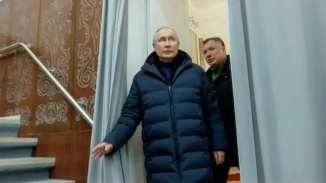 Putin escorted by Russian Deputy Prime Minister Marat Khusnullin visits the Mariupol theatre during his visit to Mariupol