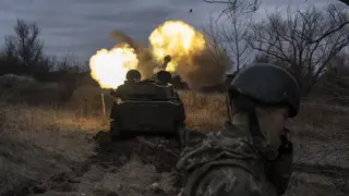 A Ukrainian artillery vehicle fires on the front line