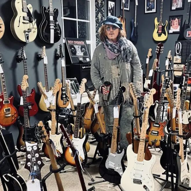 Guitar enthusiast Depp poses with classic instruments