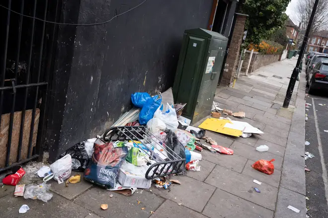 Packaging litter and food waste is spread across the pavement in a Cricklewood side street, on 6th March 2023, in London, England.