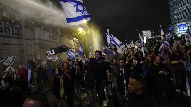 Israeli police use water cannon to disperse people in Tel Aviv protesting against plans by Prime Minister Benjamin Netanyahu’s government to overhaul the judicial system