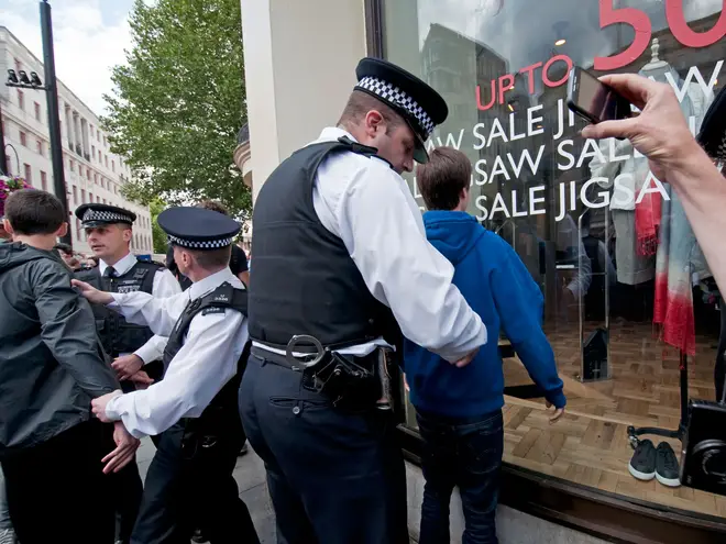 Young people are searched by Met Police officers (stock image)
