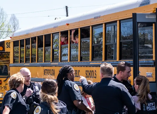 School buses with children arrive at Woodmont Baptist Church to be reunited with their families after a mass shooting at The Covenant School