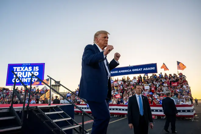 Former U.S. President Donald Trump dances while exiting after speaking during a rally at the Waco Regional Airport on March 25