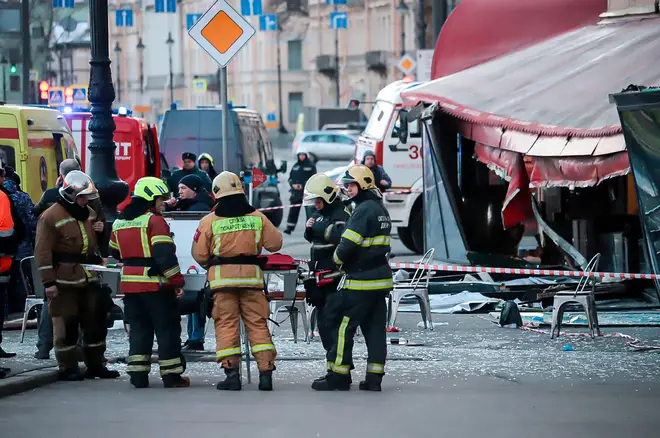 Emergency services workers at the "Street Cafe" in St Petersburg, where the blast occurred.